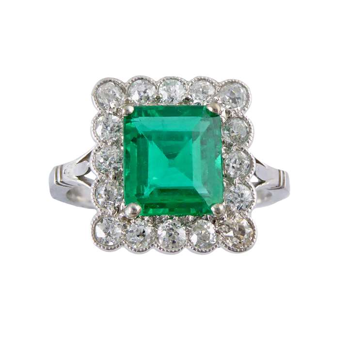 Emerald and diamond rectangular cluster ring, the cut corner emerald of step cut, approximately 1.45ct,